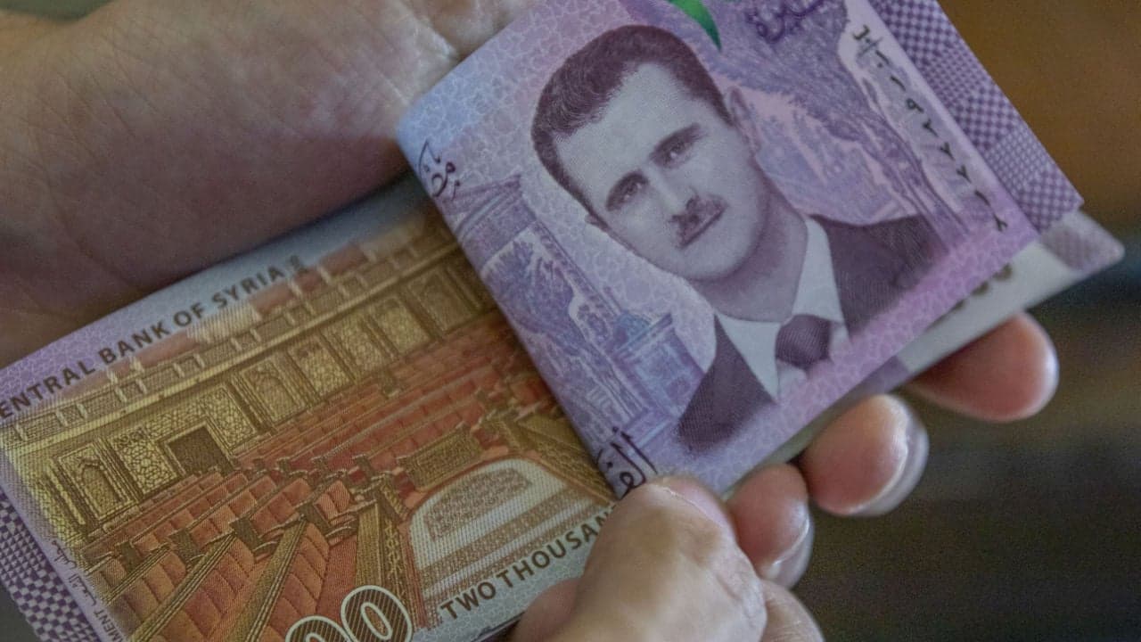 Report: Syrian Central Bank Devalues Local Currency by Nearly 50%